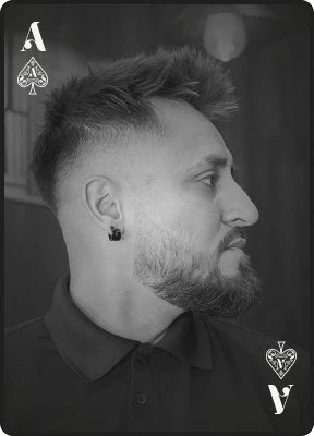 Ace of Spades card representing a professional men's haircut with a skin fade and full beard grooming service.